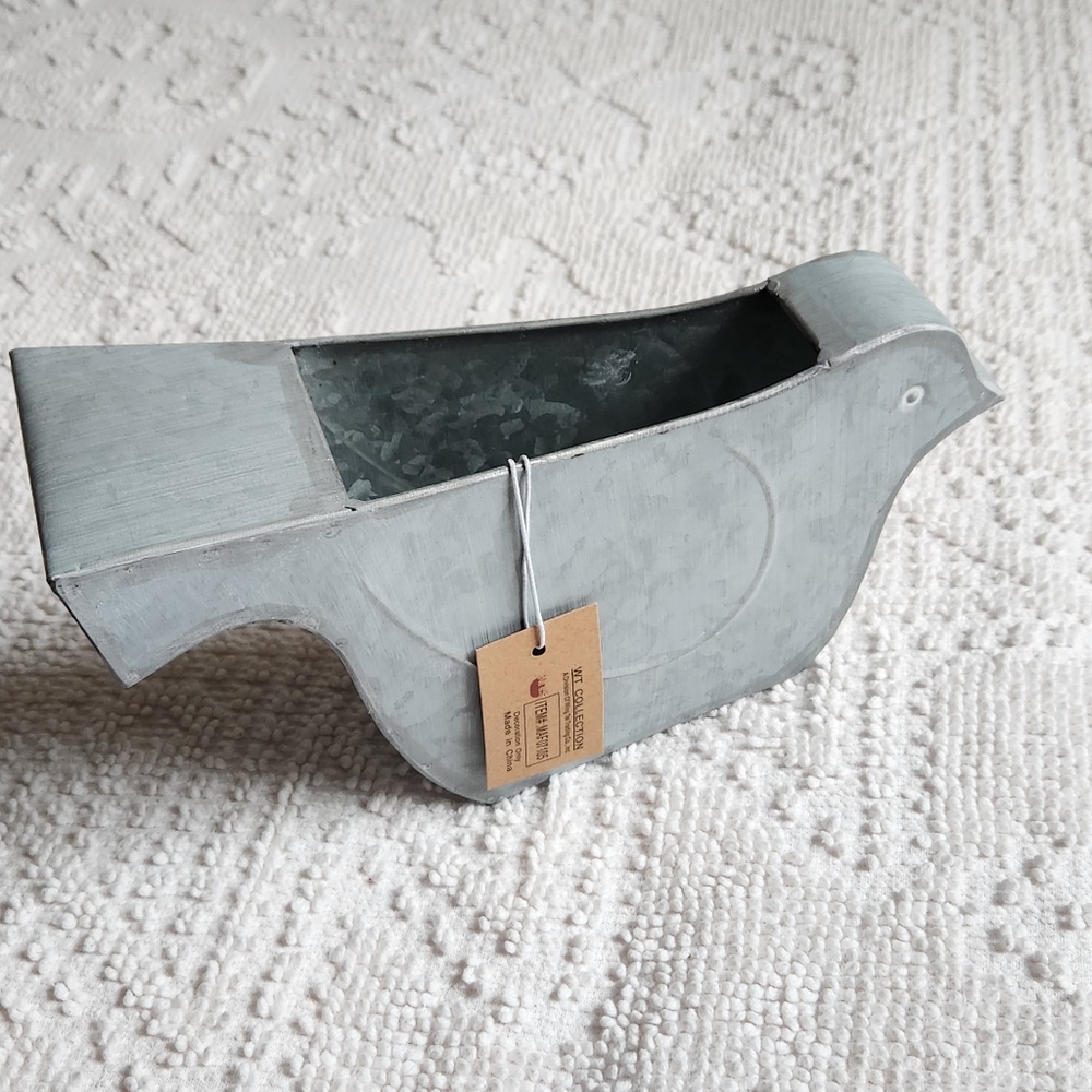 Brushed metal plant holder.